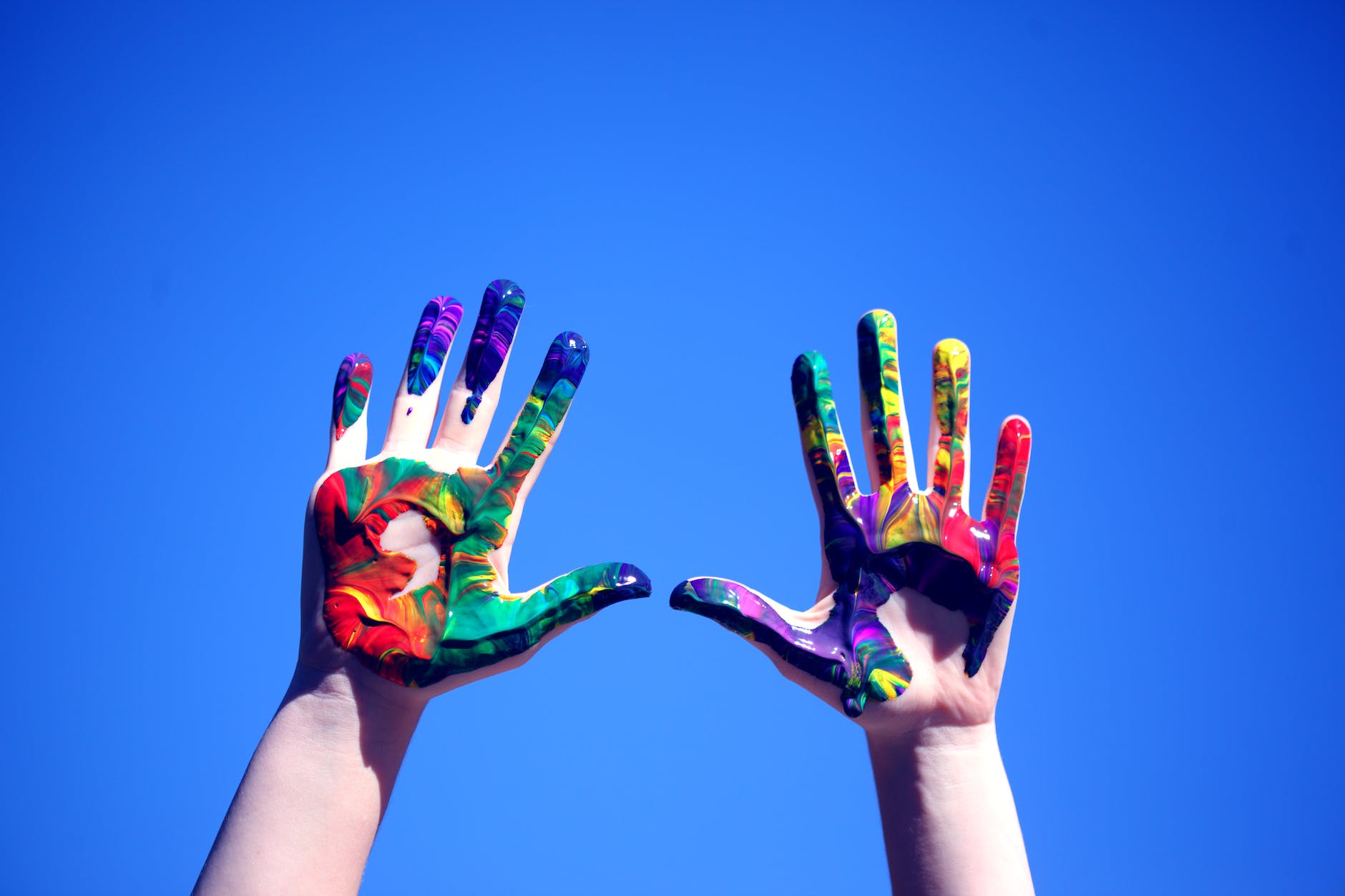 person s hands with paint