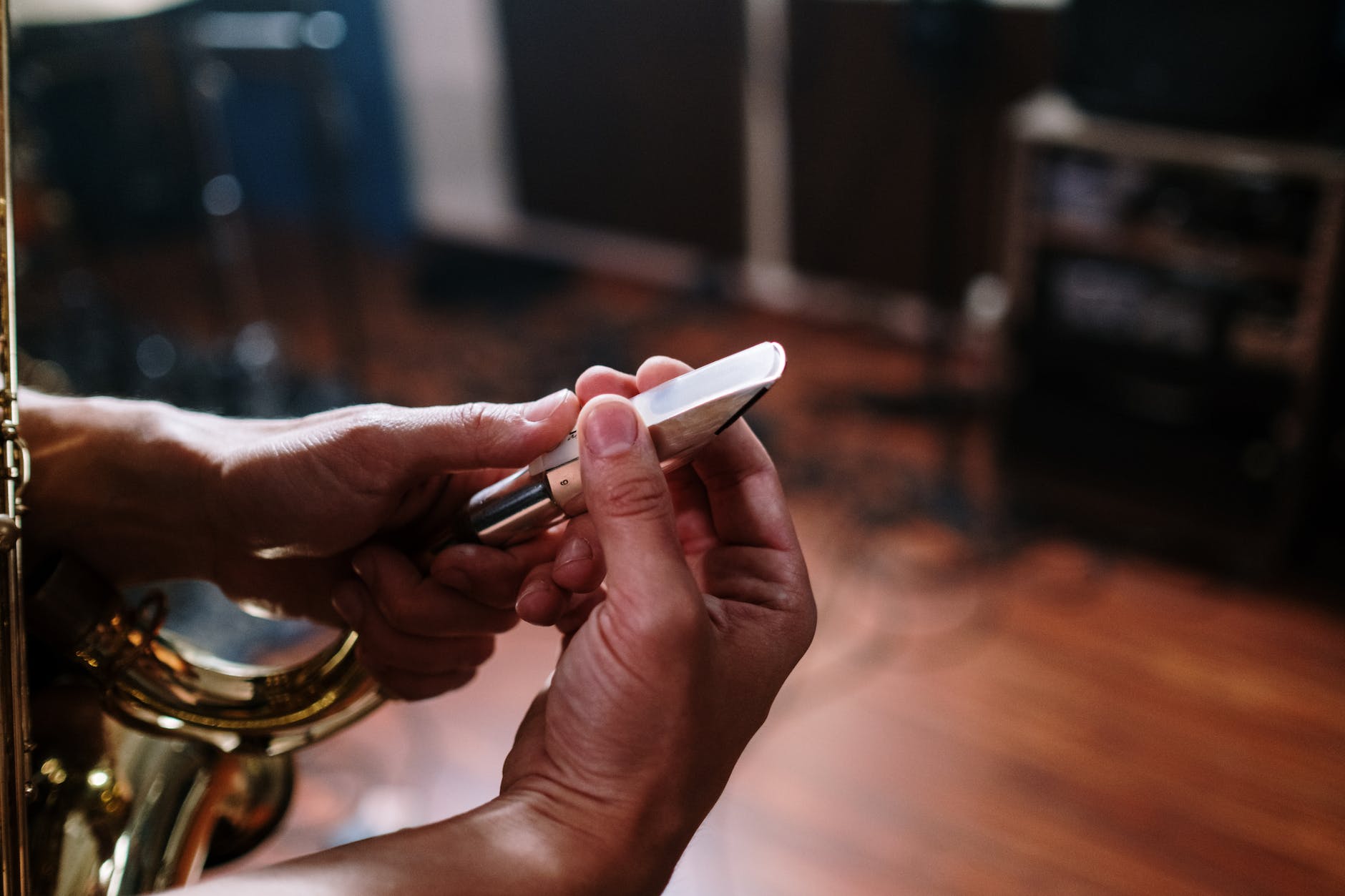 a person s hand holding saxophone mouthpiece