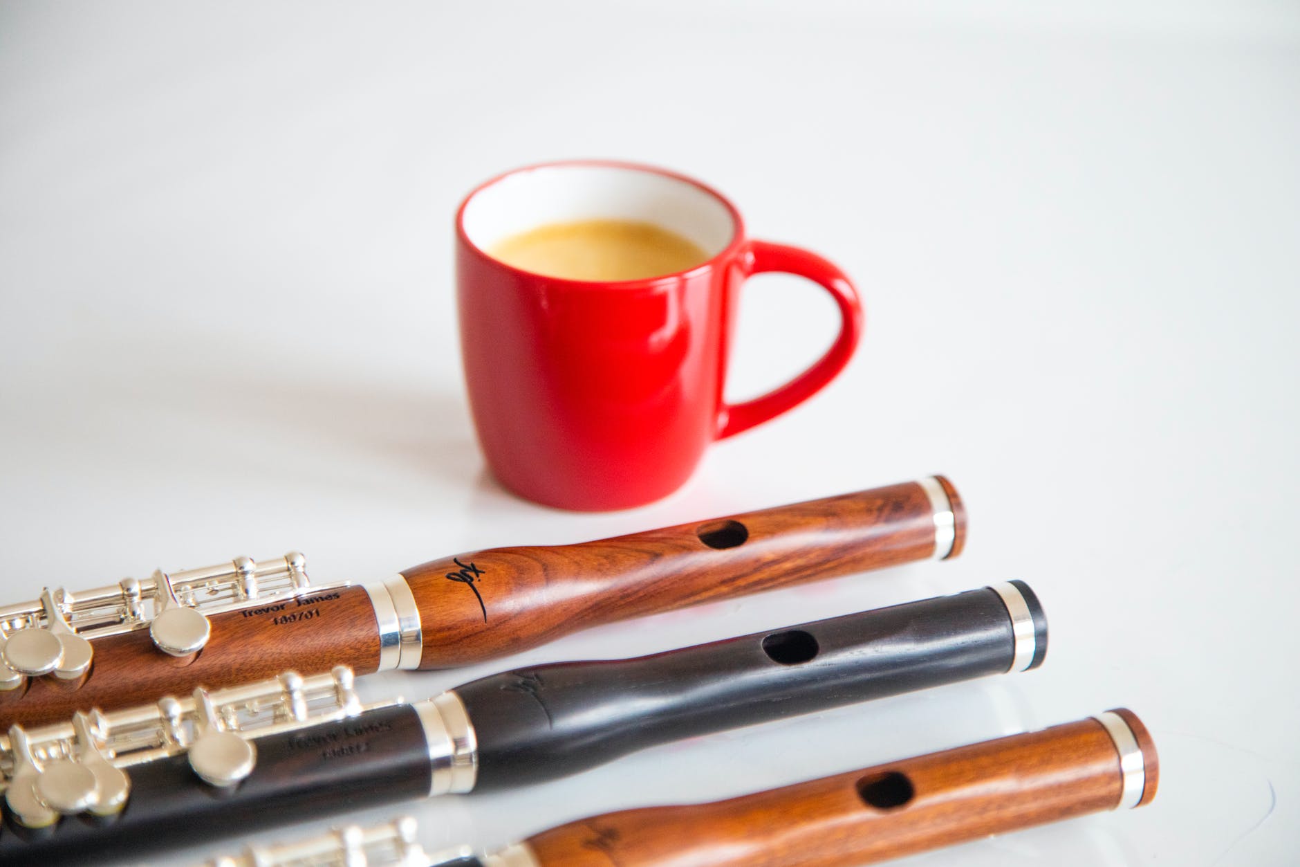 photograph of flutes near a cup of coffee